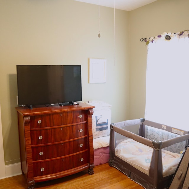 bedroom with hardwood / wood-style flooring