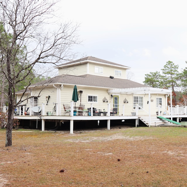 back of property with a wooden deck