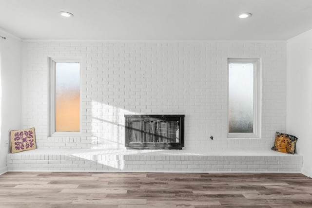 details featuring hardwood / wood-style floors, crown molding, and a fireplace