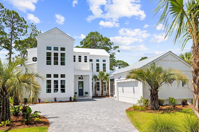 view of front of property featuring a garage and a balcony