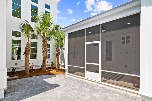 view of patio with a sunroom