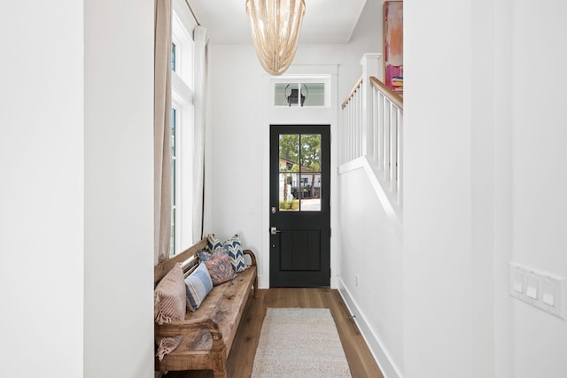 doorway featuring hardwood / wood-style floors and a notable chandelier