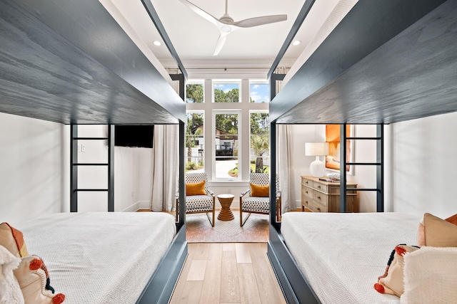 bedroom with light hardwood / wood-style flooring and ceiling fan