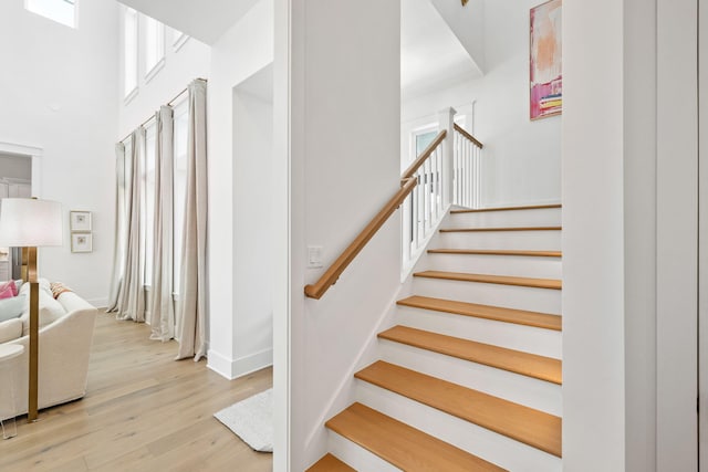 staircase featuring plenty of natural light and wood-type flooring