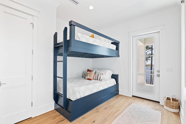 bedroom featuring light hardwood / wood-style flooring and crown molding