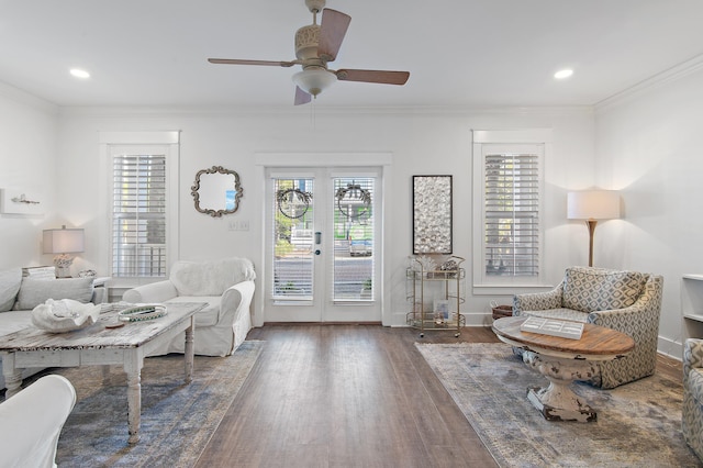 sitting room featuring dark hardwood / wood-style floors, ceiling fan, crown molding, and french doors