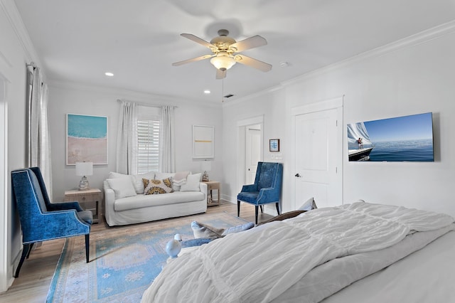 bedroom featuring hardwood / wood-style floors, ceiling fan, and ornamental molding