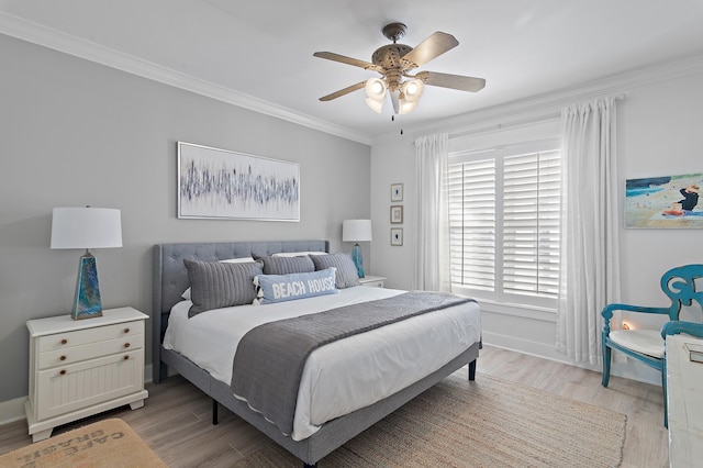 bedroom with ceiling fan, ornamental molding, and light wood-type flooring