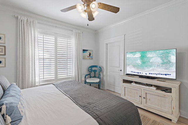 bedroom with ceiling fan and crown molding