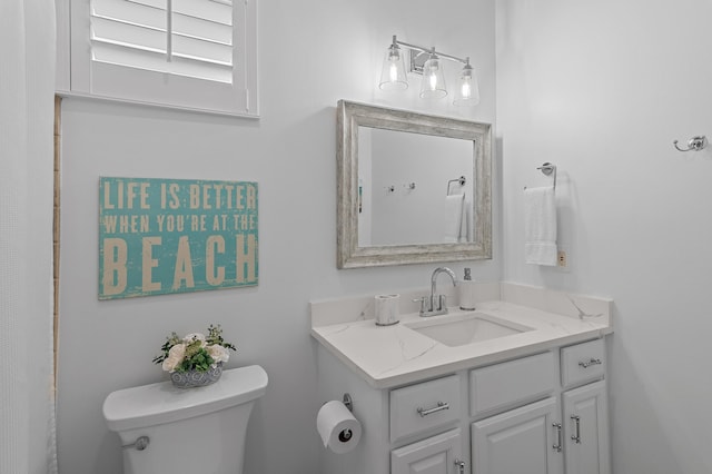 bathroom featuring vanity and toilet