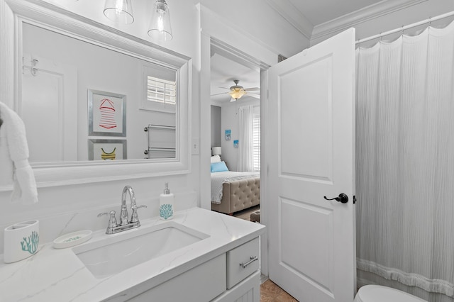 bathroom with vanity, ceiling fan, and ornamental molding