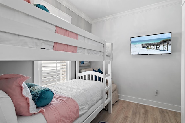 bedroom with hardwood / wood-style floors and ornamental molding