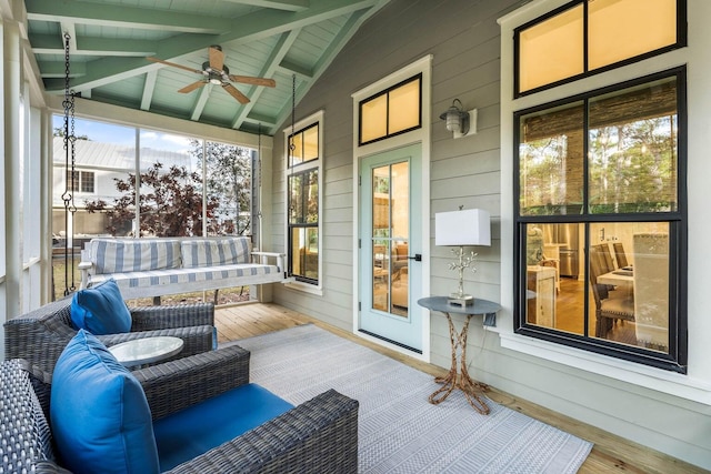 sunroom featuring vaulted ceiling with beams, ceiling fan, and wood ceiling