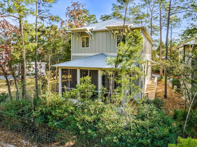 back of property with a sunroom