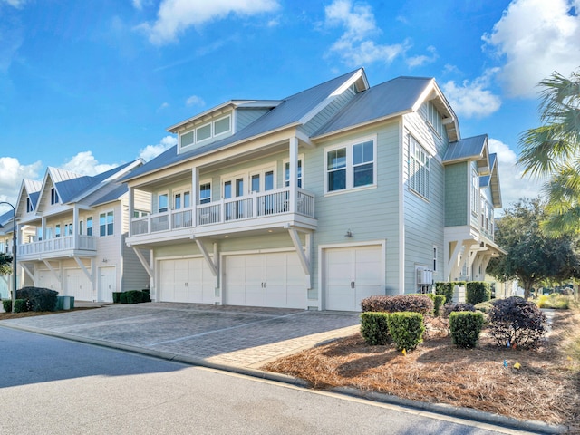 view of front of home featuring a garage and cooling unit