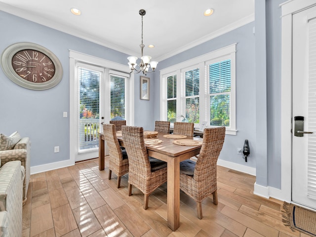 dining space featuring french doors, a chandelier, a wealth of natural light, and ornamental molding