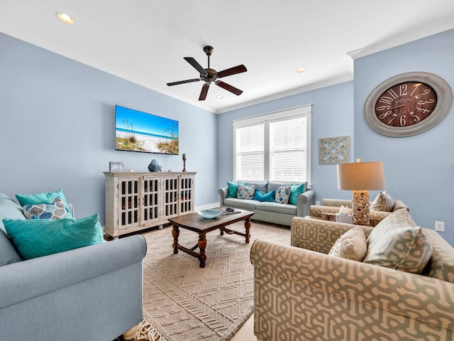 living room featuring ornamental molding and ceiling fan