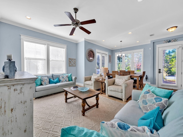 living room featuring ceiling fan with notable chandelier and ornamental molding