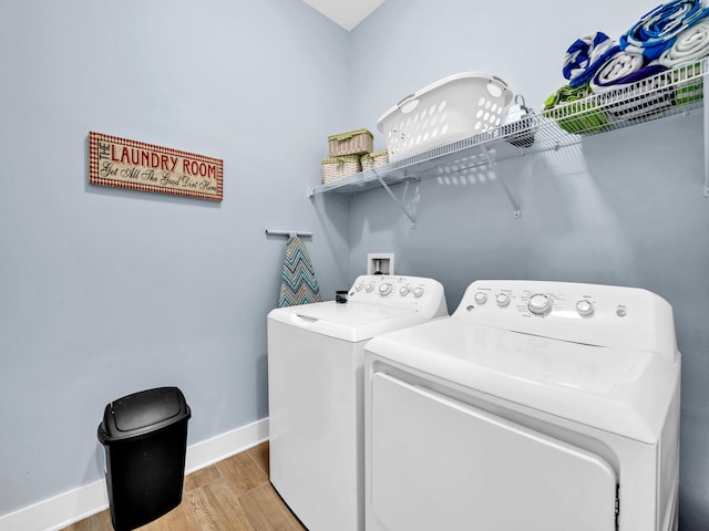 clothes washing area with light wood-type flooring and independent washer and dryer