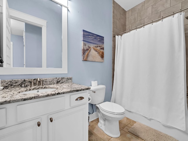 bathroom featuring toilet, a shower with curtain, tile patterned floors, and vanity