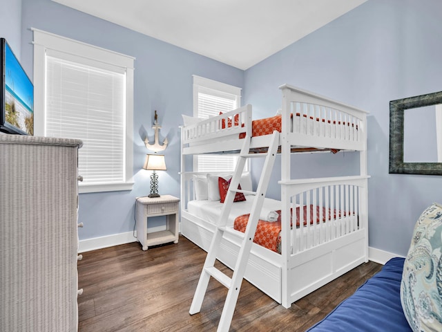 bedroom with dark wood-type flooring