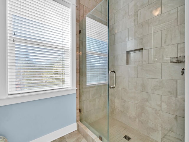 bathroom with walk in shower and tile patterned floors