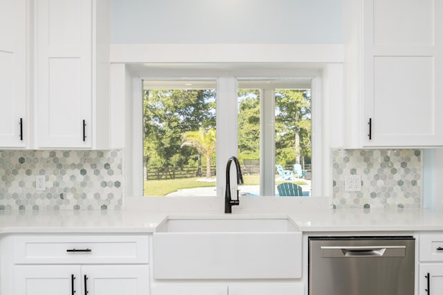 kitchen featuring white cabinetry, dishwasher, sink, and tasteful backsplash