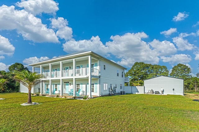 back of house with a balcony, central air condition unit, and a lawn