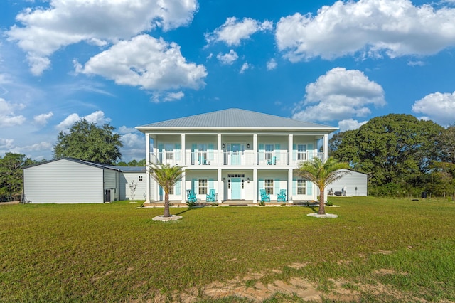 rear view of house with a yard, central AC, a balcony, and a porch