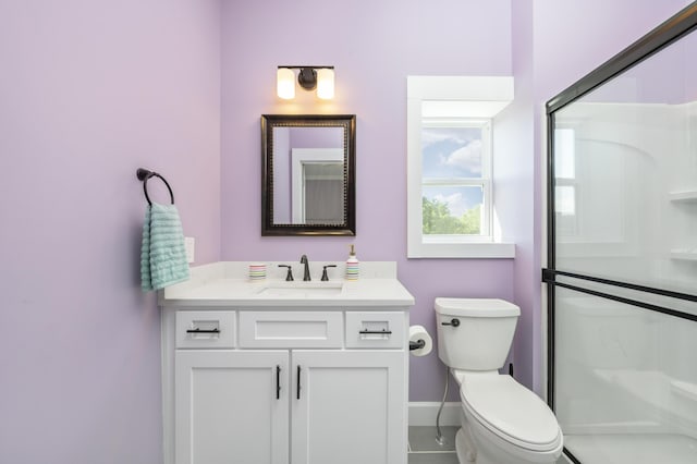 bathroom with vanity, walk in shower, and toilet