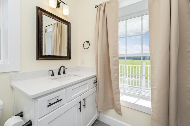 bathroom featuring vanity and toilet