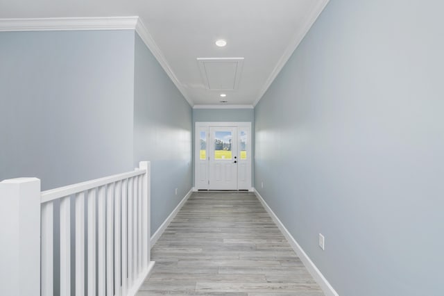 doorway to outside featuring crown molding and light hardwood / wood-style flooring