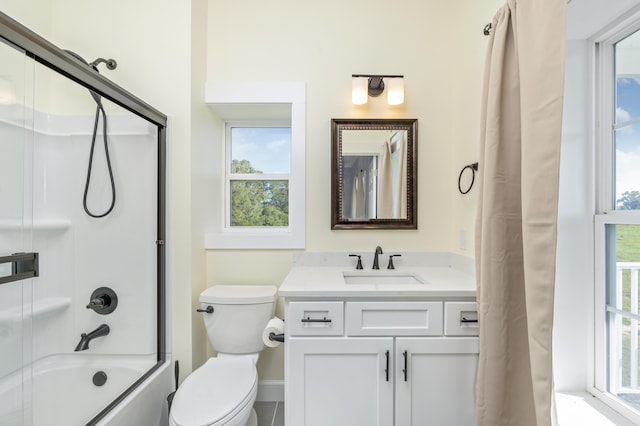 full bathroom with vanity, shower / tub combo with curtain, and toilet