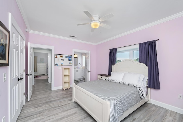 bedroom featuring ceiling fan, ornamental molding, ensuite bathroom, and light wood-type flooring