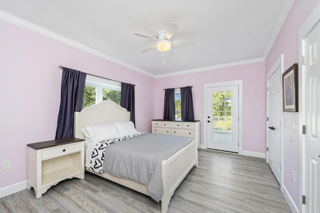 bedroom with multiple windows, access to outside, and light hardwood / wood-style flooring