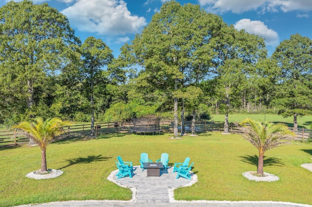 view of yard featuring an outdoor fire pit and a patio