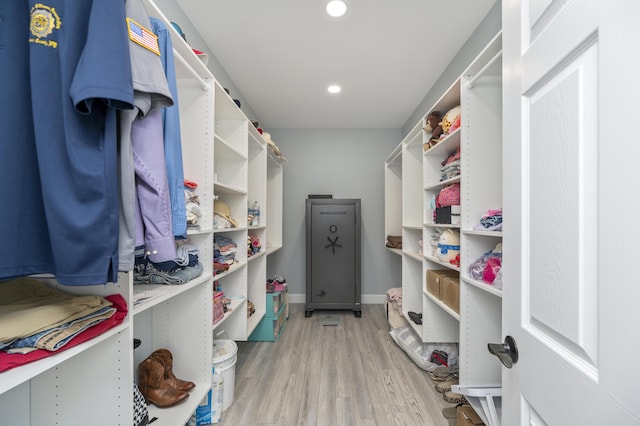 walk in closet with light wood-type flooring