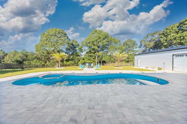 view of swimming pool with a yard and a patio area