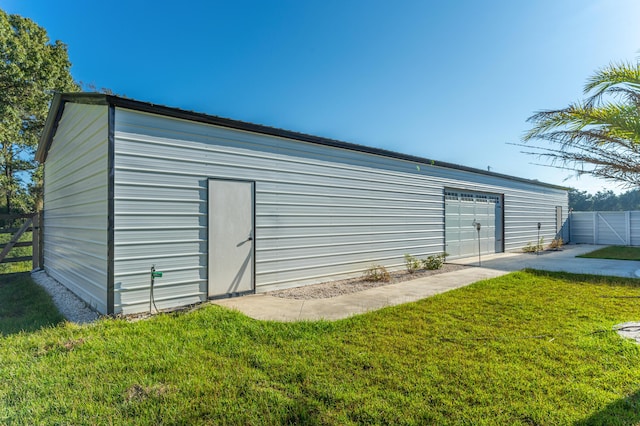 view of outdoor structure with a garage and a yard