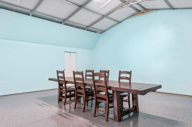 dining space featuring lofted ceiling