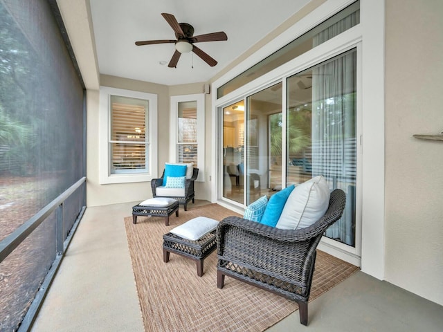 sunroom / solarium featuring ceiling fan