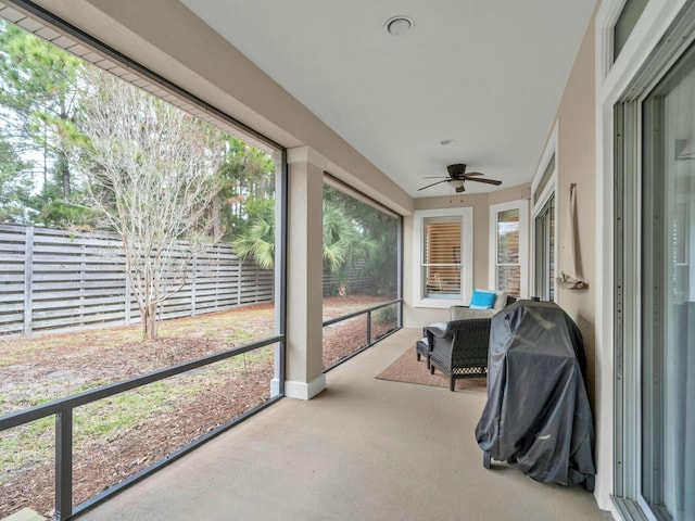 sunroom / solarium featuring ceiling fan