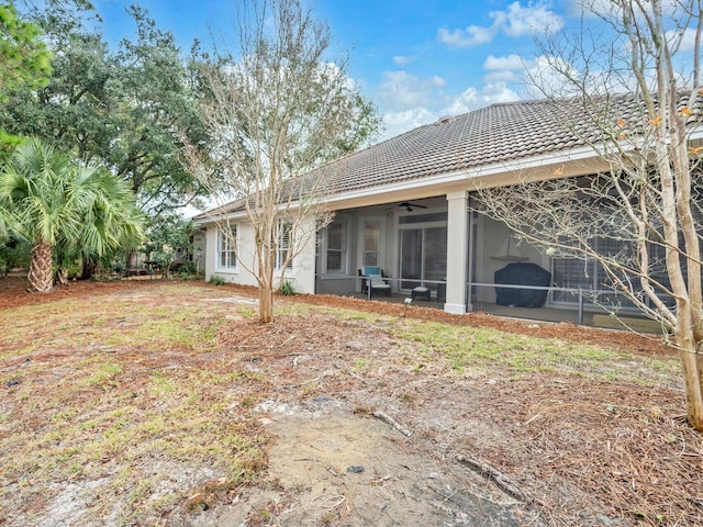 rear view of house featuring a sunroom