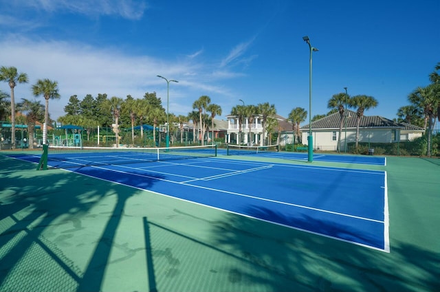 view of tennis court featuring basketball hoop