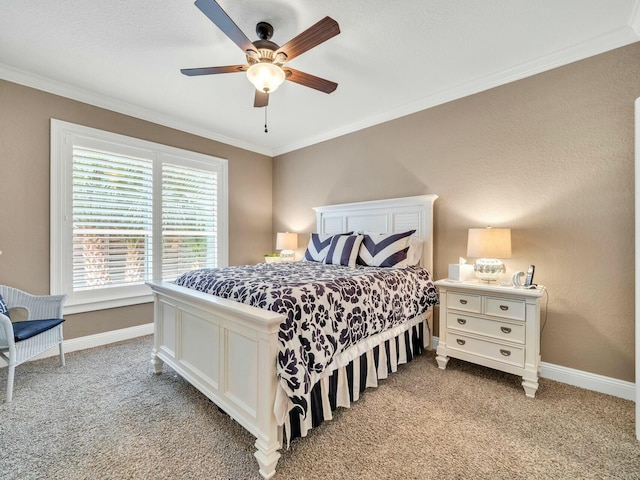 carpeted bedroom with ceiling fan and crown molding