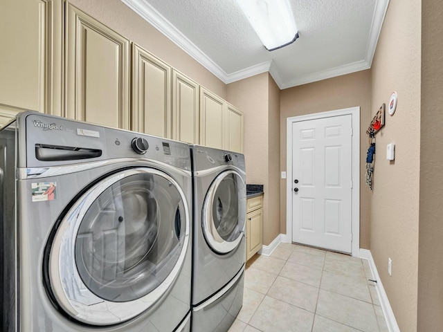 laundry room with light tile patterned floors, cabinets, a textured ceiling, and independent washer and dryer