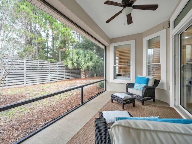 sunroom with a wealth of natural light and ceiling fan