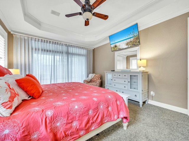 carpeted bedroom featuring a tray ceiling, ceiling fan, and ornamental molding