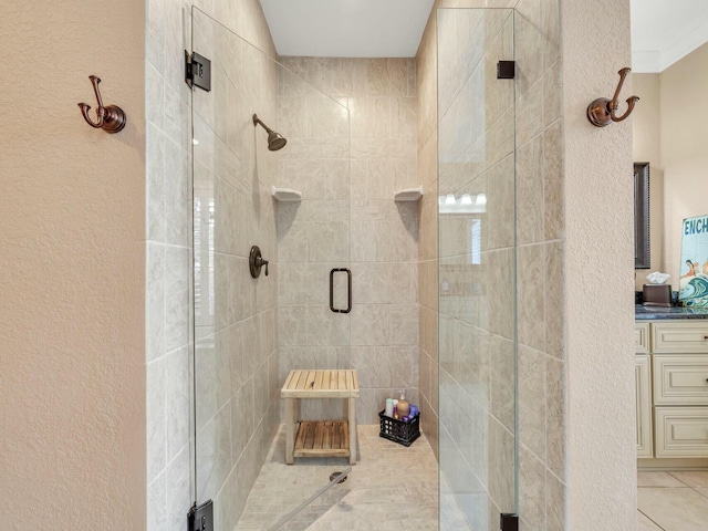 bathroom featuring tile patterned floors, vanity, and an enclosed shower