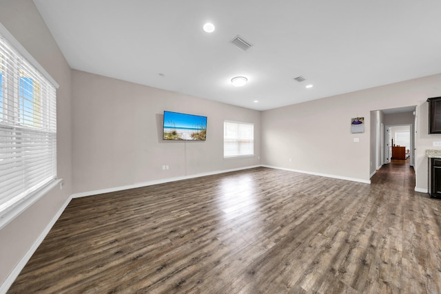 unfurnished living room featuring dark wood-type flooring